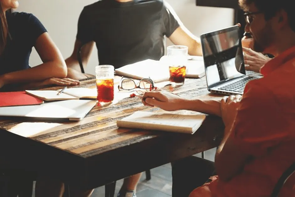 people having a meeting over coffee and tea