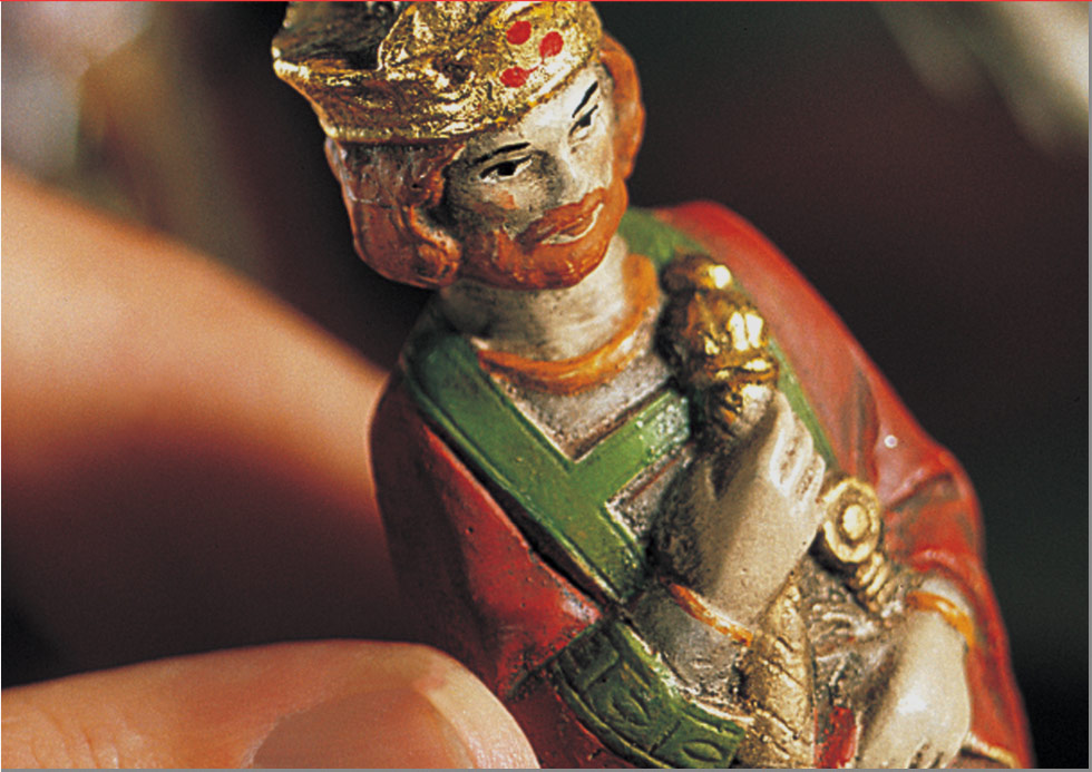 a person holding a king chess piece