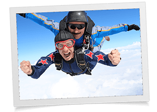 photograph of two people going skydiving